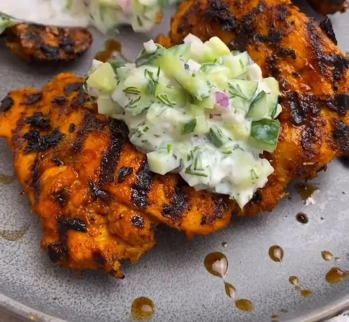 Fiery Mediterranean Chicken served with cucumber salad on a plate