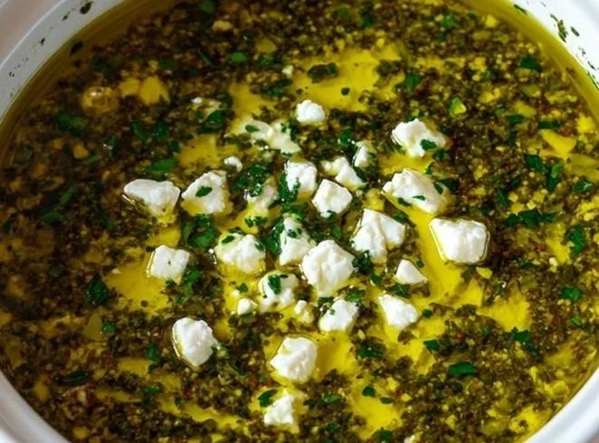 A variety of flavorful dips served with fresh vegetables and chips.