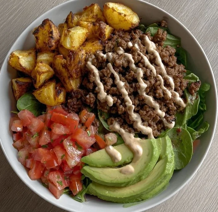 Healthy high-protein burger stacked with fresh ingredients and served on a plate.