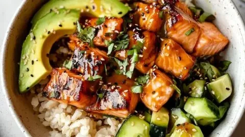 Delicious honey glazed salmon bowl topped with vegetables and served in a healthy dinner plate.