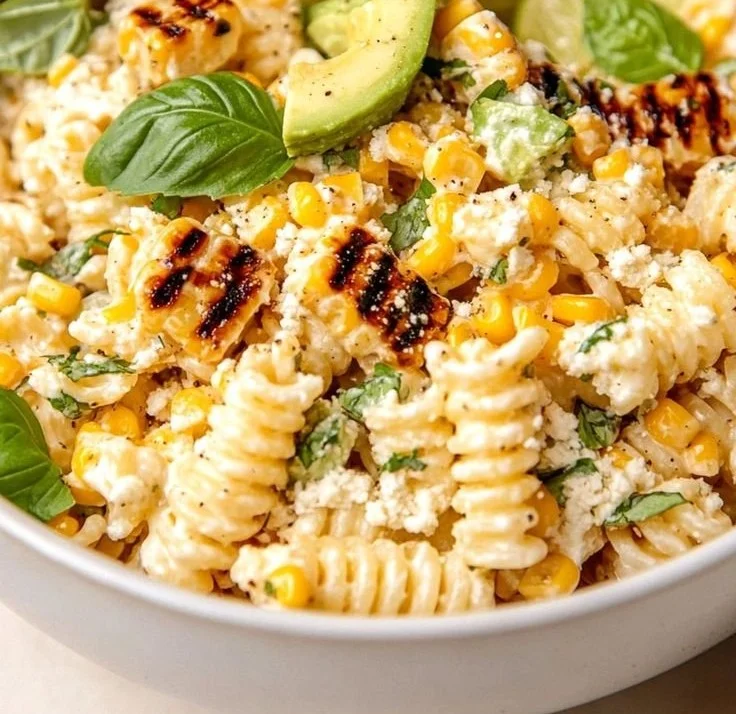 Juicy Street Corn Pasta Salad in a colorful bowl garnished with fresh ingredients