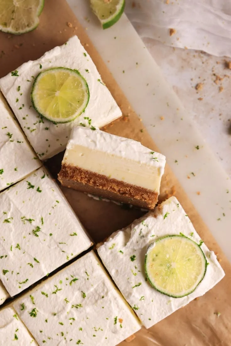 Delicious Key Lime Pie Bars topped with lime zest and whipped cream