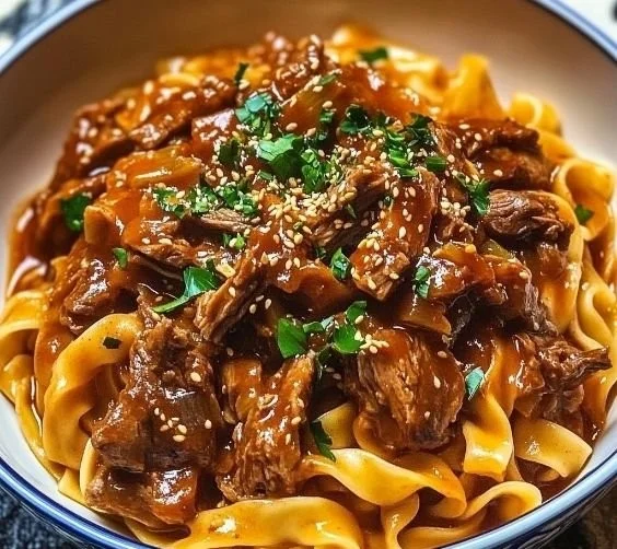 Delicious Korean beef noodles served in a bowl with herbs and spices