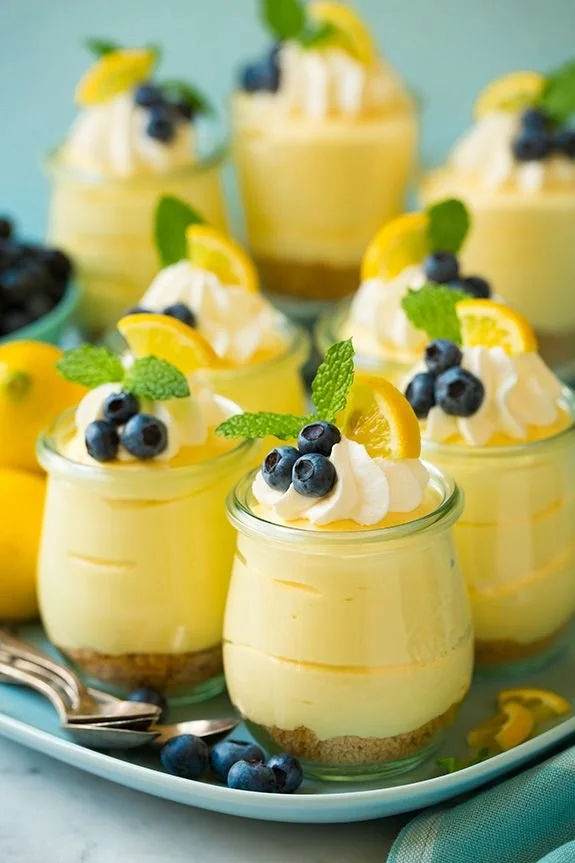 Delicious lemon cheesecake mousse topped with lemon zest and whipped cream