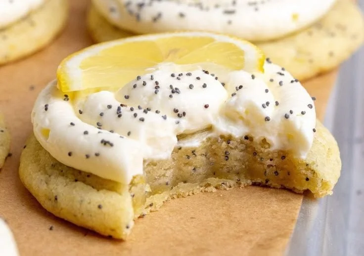 Lemon poppy seed cookies with cheesecake frosting on a decorative plate