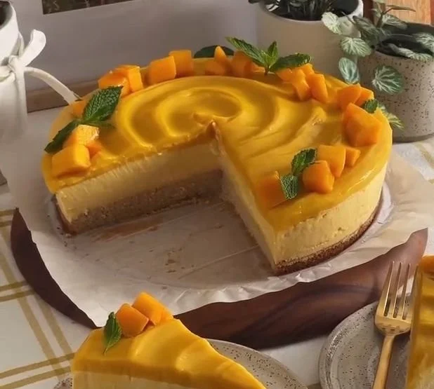 Delicious mango mousse cake with a creamy texture and fresh mango toppings.