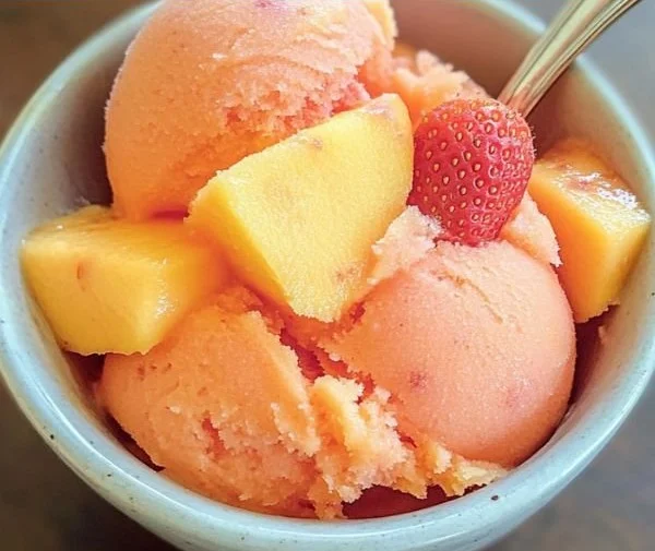 Delicious Mango Strawberry Sorbet served in a bowl with fresh fruits