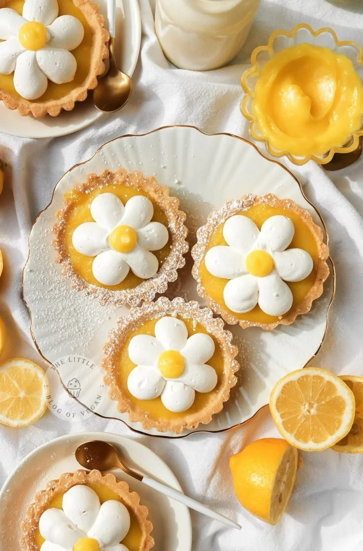 Mini Vegan Lemon Tarts served on a plate, garnished with lemon zest