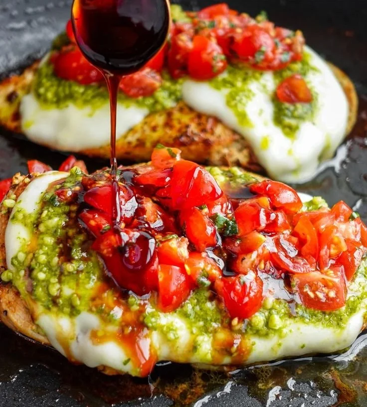 Pesto Bruschetta Chicken topped with fresh basil and tomatoes