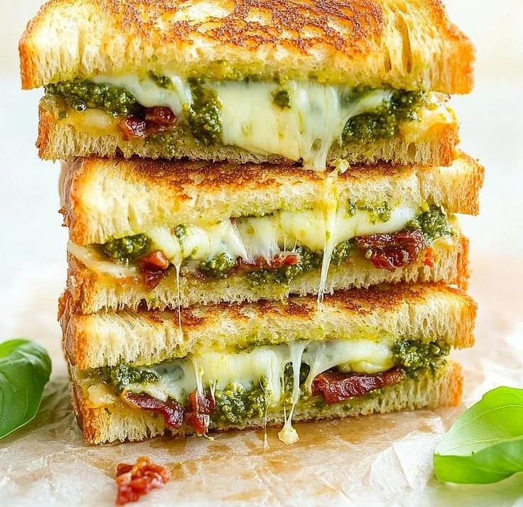 A mouthwatering Pesto Grilled Cheese sandwich with melted cheese and vibrant pesto.