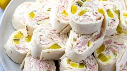 Delicious pickle dip pinwheels served on a platter.