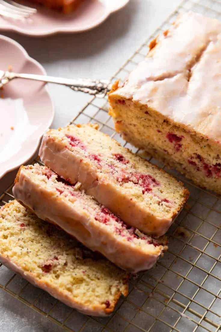 Sliced Raspberry Lemon Poppyseed Loaf Cake on a plate