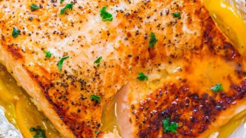 Sheet Pan Lemon Garlic Butter Salmon garnished with fresh herbs