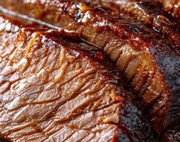 Tender slow cooker beef brisket served on a plate with sides