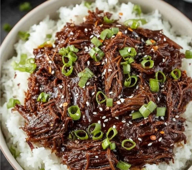 Delicious Slow Cooker Korean Beef served with rice and vegetables