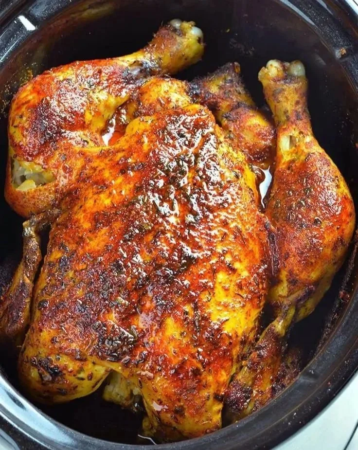 Delicious slow cooker rotisserie chicken served with herbs and spices.