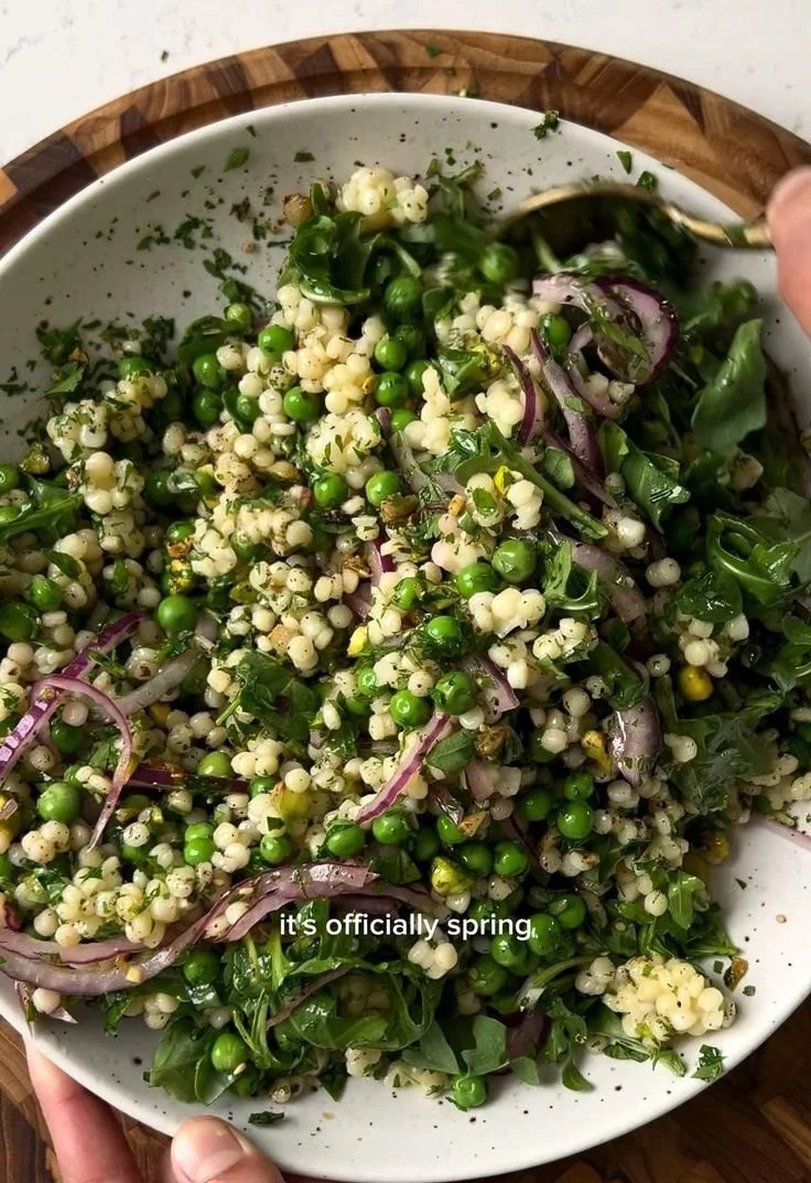 Bright and colorful Spring Couscous Salad with fresh vegetables and herbs