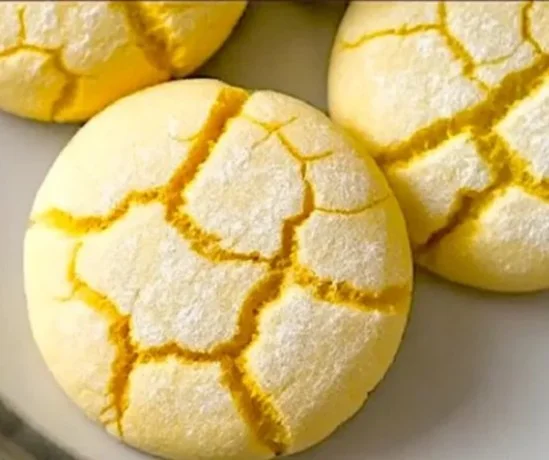Deliciously baked Springtime Crinkle Cookies with powdered sugar coating
