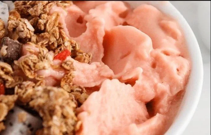 Delicious watermelon smoothie bowl topped with fresh fruits and seeds