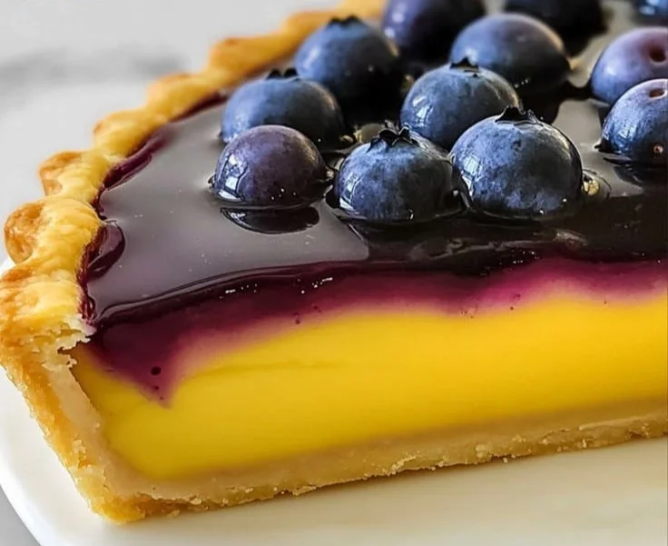 Delicious Blueberry–Lemon Curd Tart garnished with fresh berries.