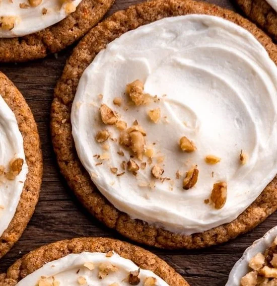 Chewy carrot cake cookies with cream cheese frosting on a plate