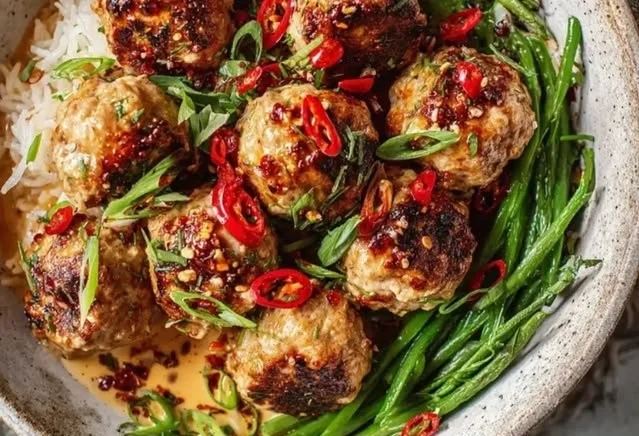 Plate of spicy Firecracker Meatballs garnished with herbs