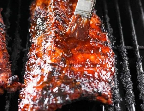 Delicious grilled ribs on a barbecue grill with smoky flavor