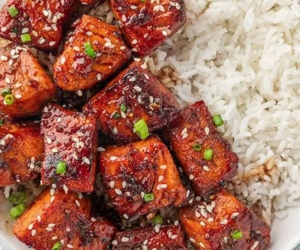 Plate of honey glazed salmon bites garnished and ready to serve