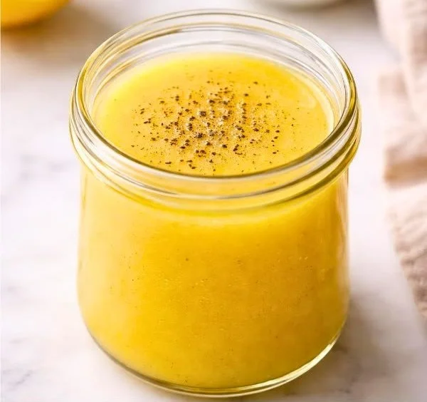 Ina Garten's lemon vinaigrette drizzled over a fresh garden salad