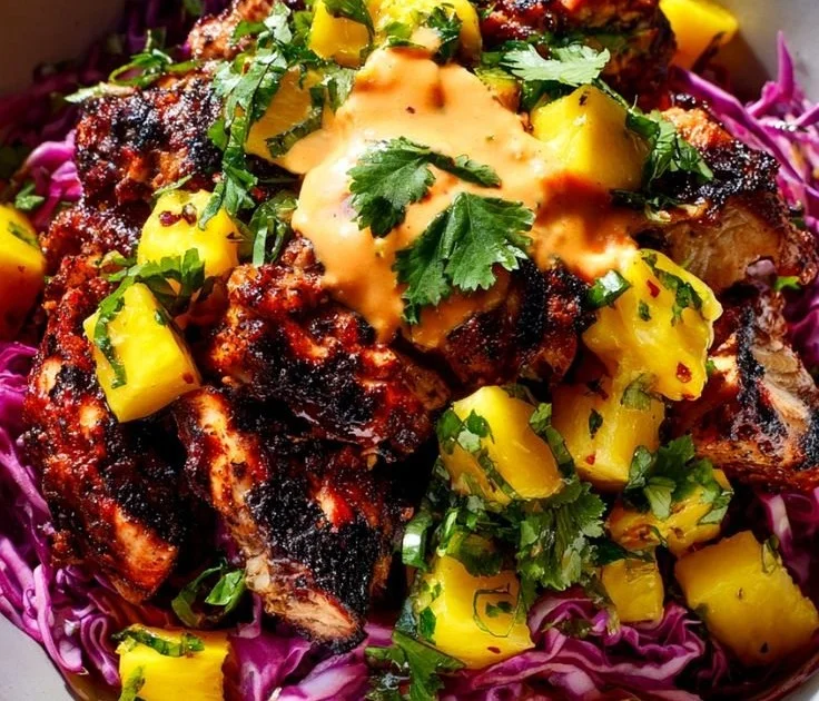 Delicious jerk chicken bowl garnished with mango-lime slaw