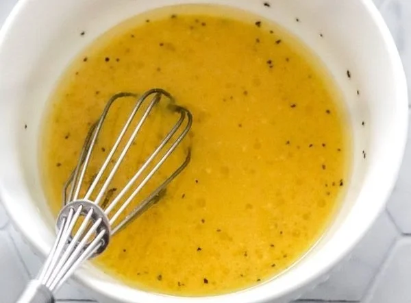 Delicious homemade kale salad dressing in a jar with fresh ingredients