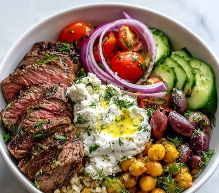 Mediterranean Steak Bowl with grilled beef, fresh vegetables, and herbs