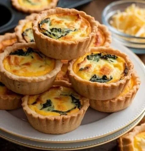 Mini quiche muffins baked in muffin tins with colorful vegetables