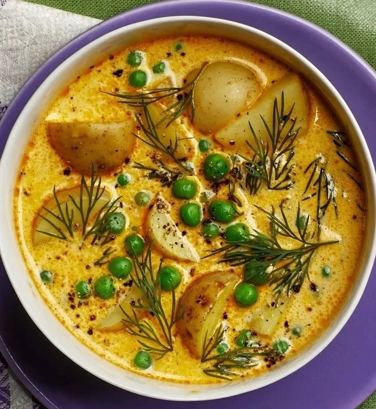 Bowl of Pea and Potato Chowder garnished with herbs