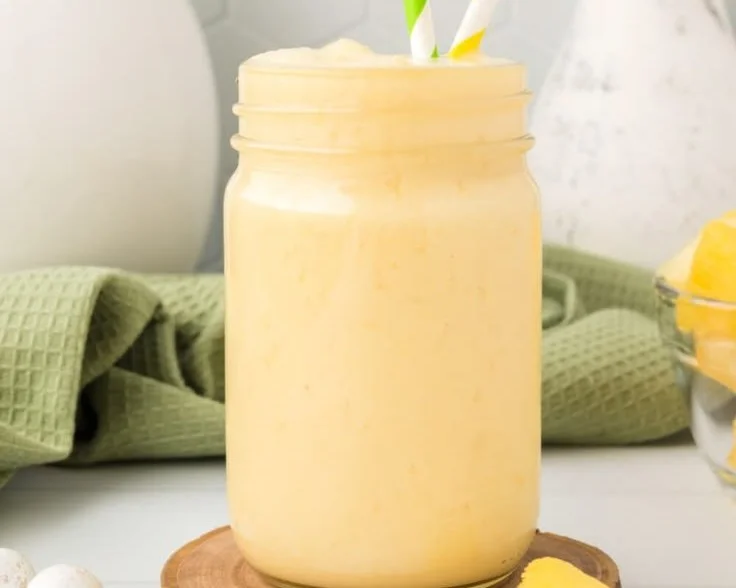 Delicious pineapple orange smoothie in a glass with a tropical garnish