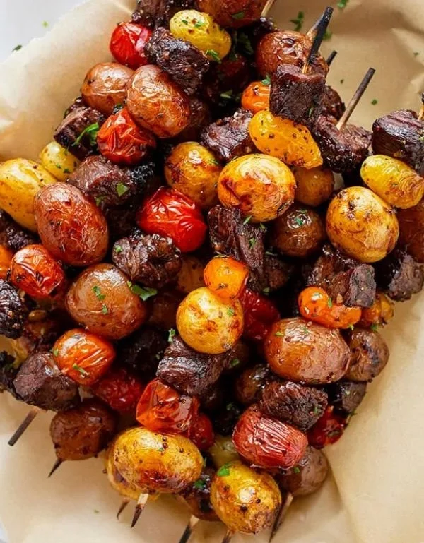 Grilled steak kabobs with colorful peppers and onions on skewers