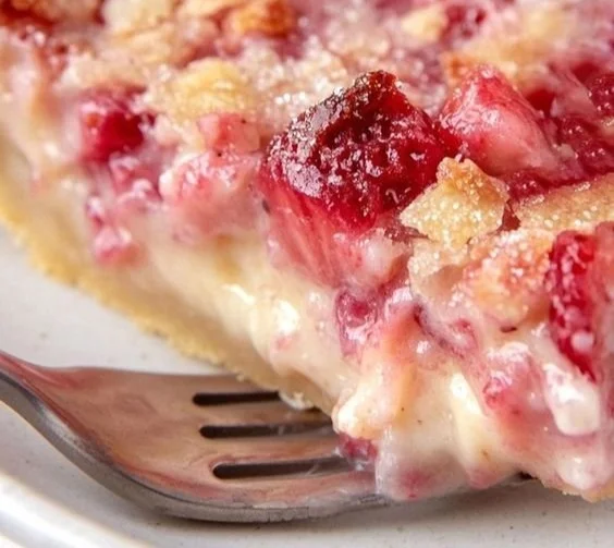 Delicious slice of Strawberry Rhubarb Pie with a flaky crust and vibrant filling