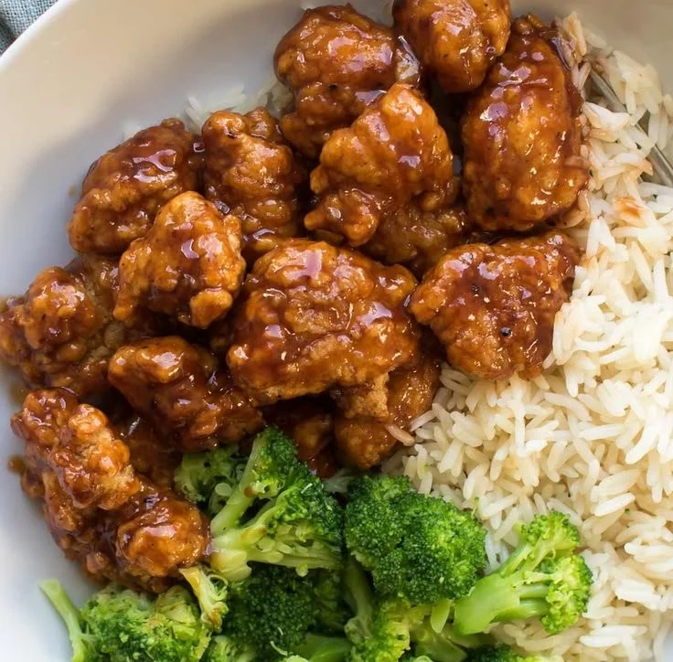 Plate of super easy orange chicken garnished with green onions