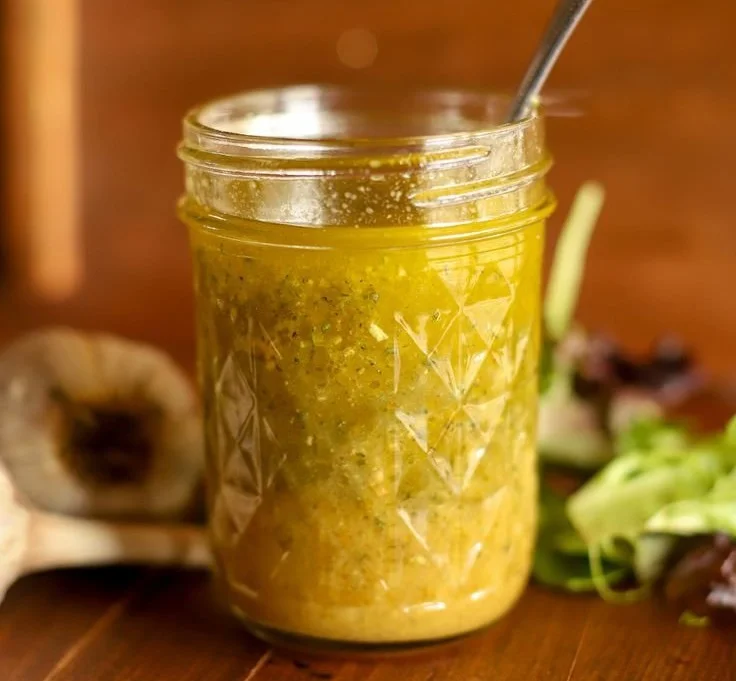 A bowl of fresh salad dressed with homemade salad vinaigrette