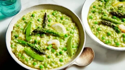 Bowl of velvety spring risotto with mascarpone and fresh vegetables