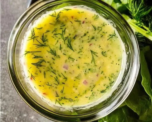 Zesty lemon dill vinaigrette drizzled over a vibrant salad.