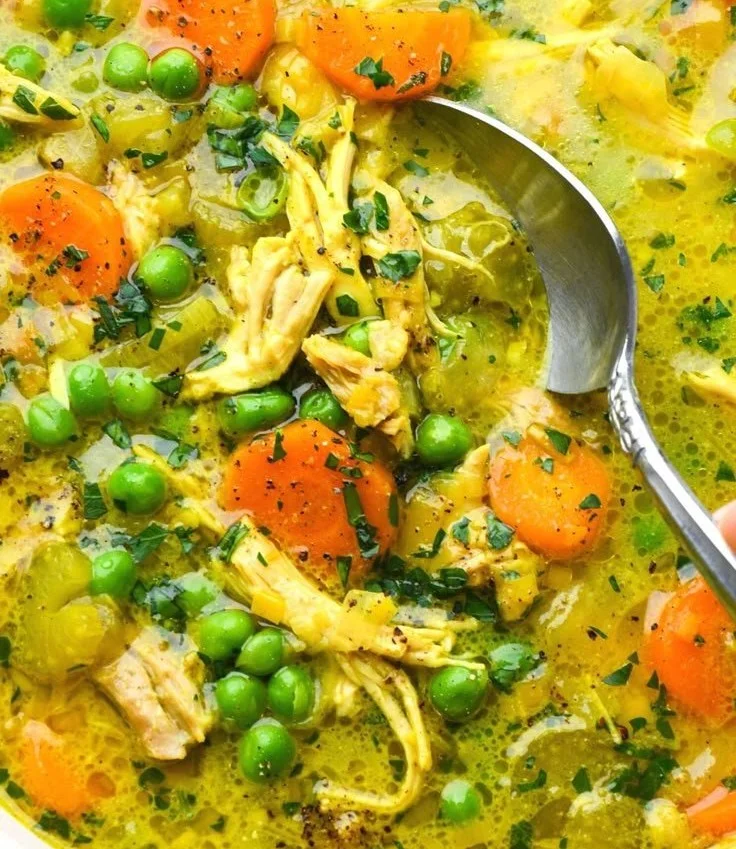 Bowl of anti-inflammatory turmeric chicken soup with herbs and spices
