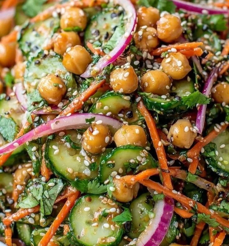 Bowl of Asian Cucumber Chickpea Slaw with sesame dressing and vegetables