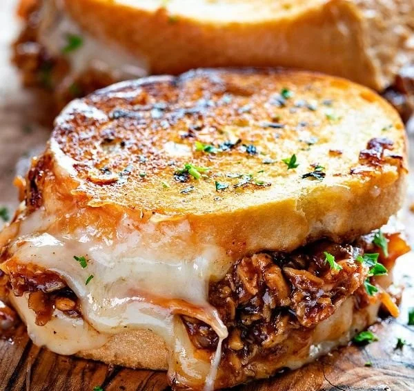BBQ chicken grilled cheese sandwich with melted cheese and smoky BBQ sauce.