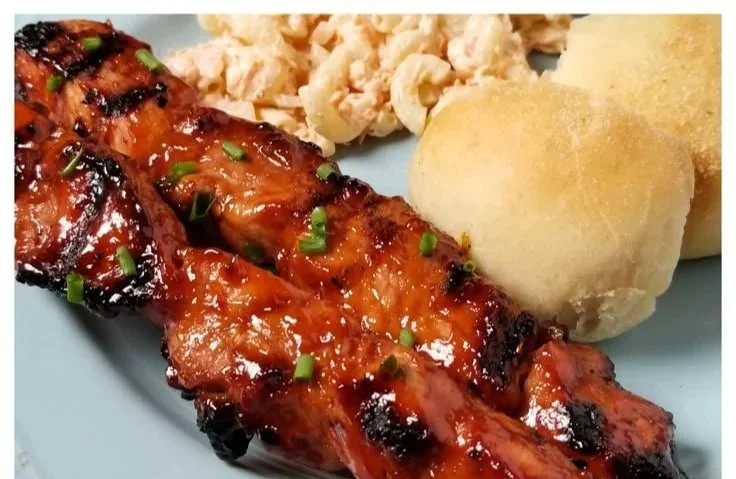 Grilled BBQ pork skewers marinated in Filipino spices on a serving platter