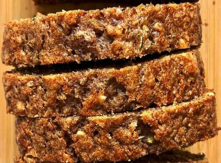 Deliciously moist zucchini bread on a wooden cutting board