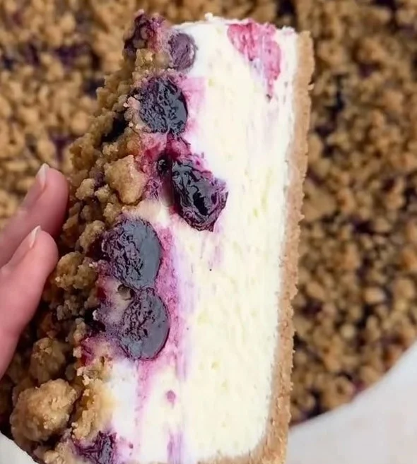 Blueberry cheesecake topped with a crumble cookie crust