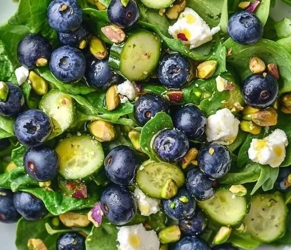 Blueberry pistachio spring salad with fresh greens and vibrant toppings