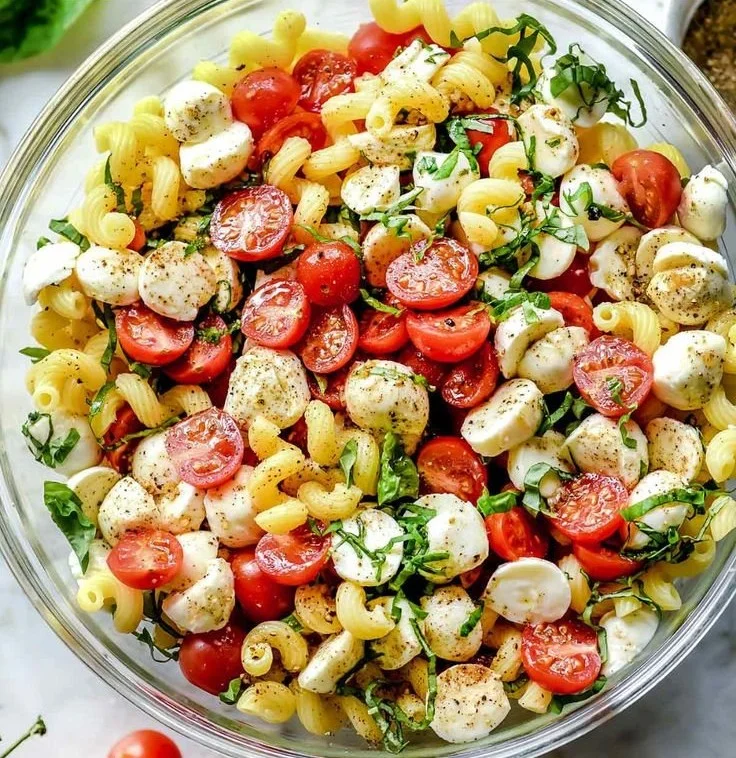 Delicious Caprese Pasta Salad with tomatoes, mozzarella, and basil in a bowl
