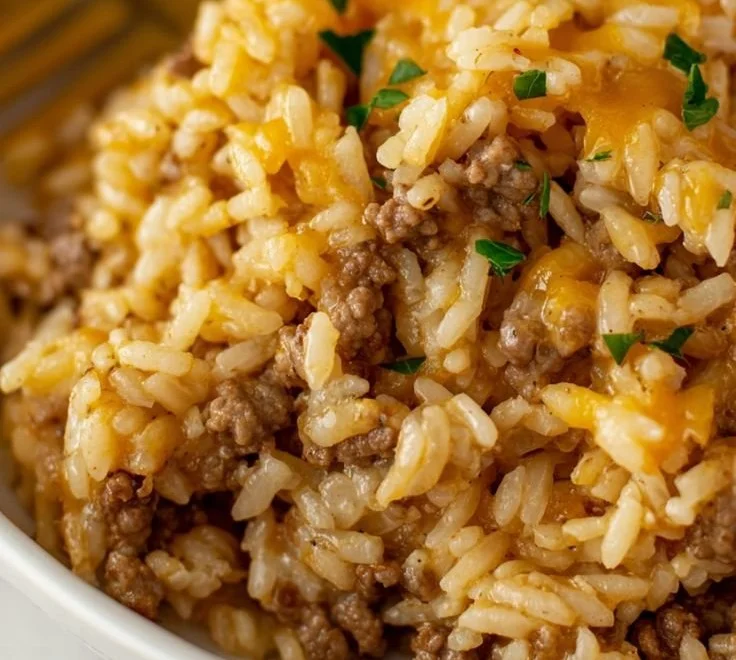 Cheesy ground beef and rice casserole ready to serve in a baking dish
